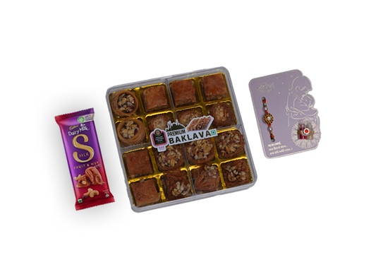 Box of baklava with a packet of chocolate and a card on a white background