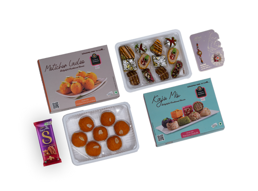 Assorted sweet treats including boxes, trays, and a chocolate bar on a white background