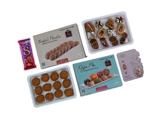 Assorted food items including a box of Thabli Penda, a box of Kaju Mix, and a small packet on a white background.